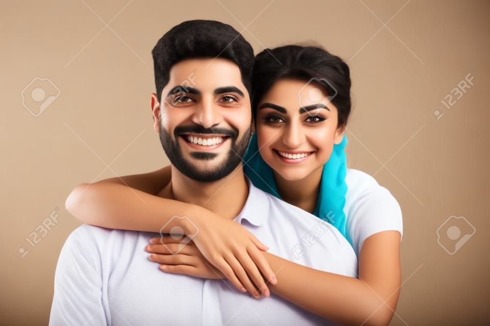 Happy Arab Couple. Portrait of Cheerful Middle Eastern Man And Woman Hugging