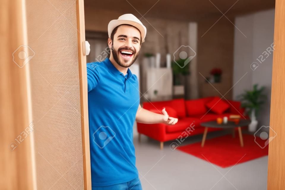 Cheerful guy inviting people to enter home