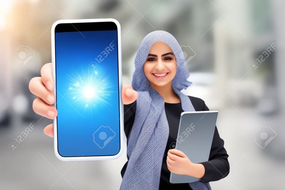 Great App. Happy Arab Student Female Showing Smartphone With Empty Screen