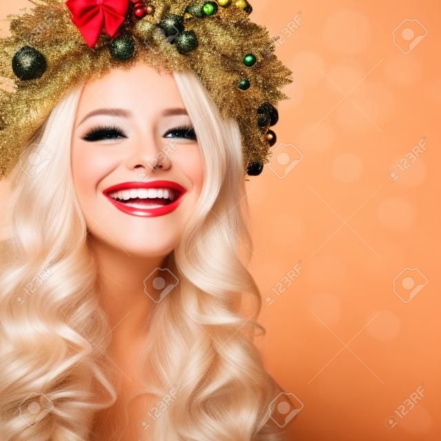 Christmas or New Year Beauty. Smiling Model Woman with Blonde Hair and Makeup Laughing. Girl with Blonde Curly Hairstyle on Party Background