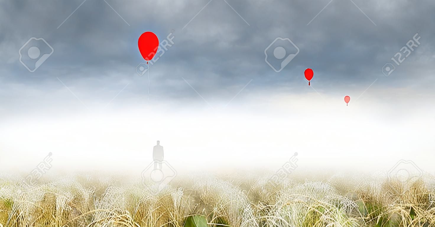 Silhouet van rode balon en vreemde man in verre mist. Eng, surrealistisch landschap.