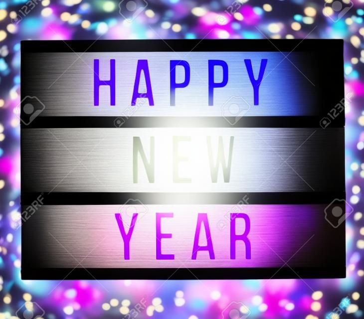 Blur, soft focus light box with Happy New Year text. bokeh