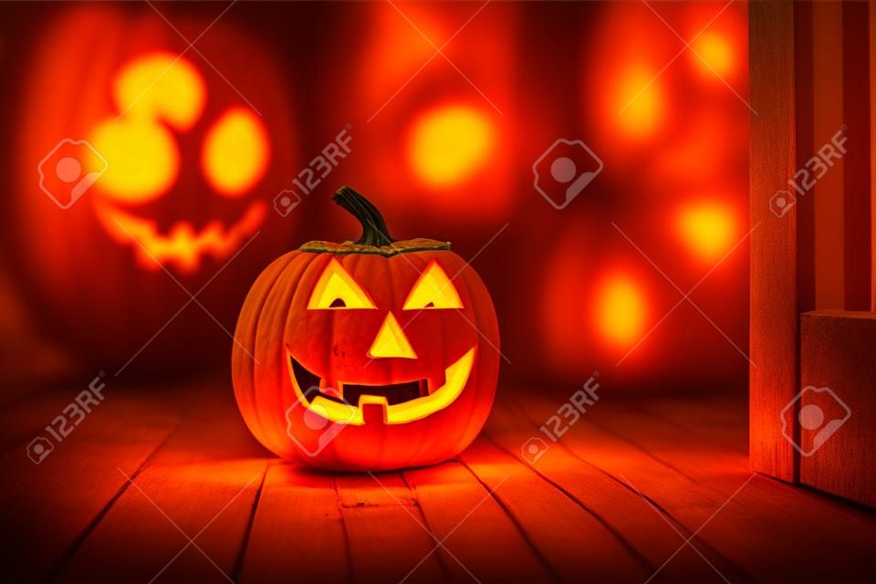 Halloween pumpkin head jack-o-lantern on wooden floor