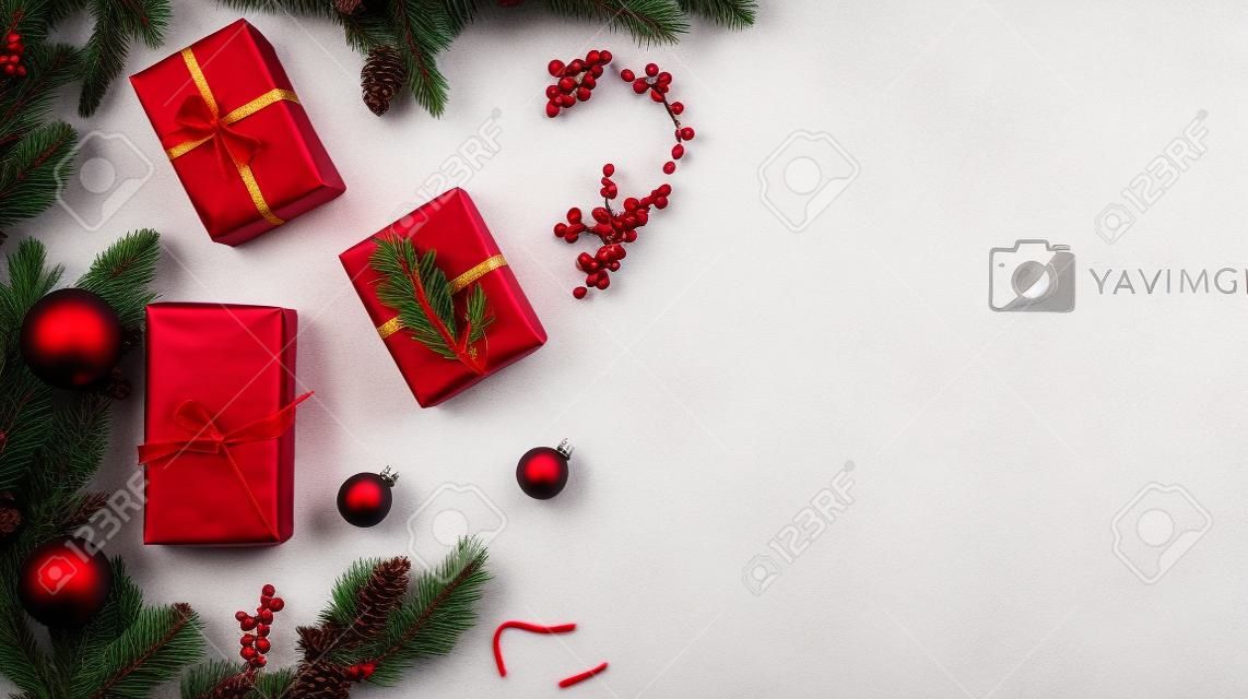 Christmas composition. Gifts, pine cones, red berries on white background. Flat lay, top view, copy space