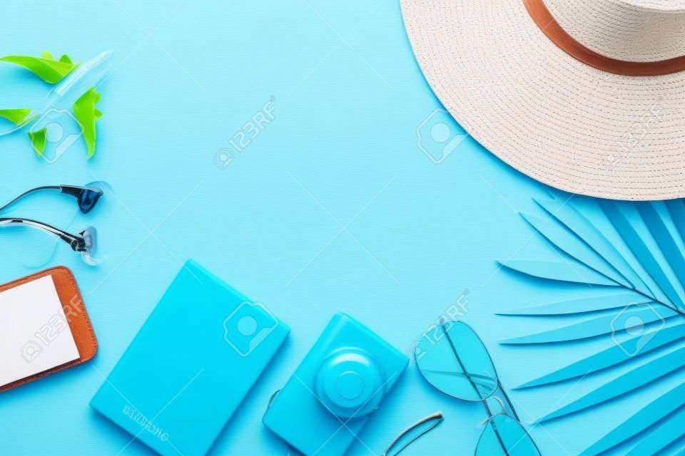 Top view, flat lay object accessories of travel or summer vacation concept with blank space on blue background.