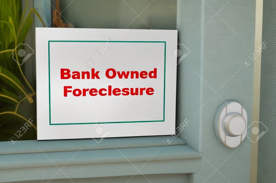 Bank owned foreclosure sign on home.