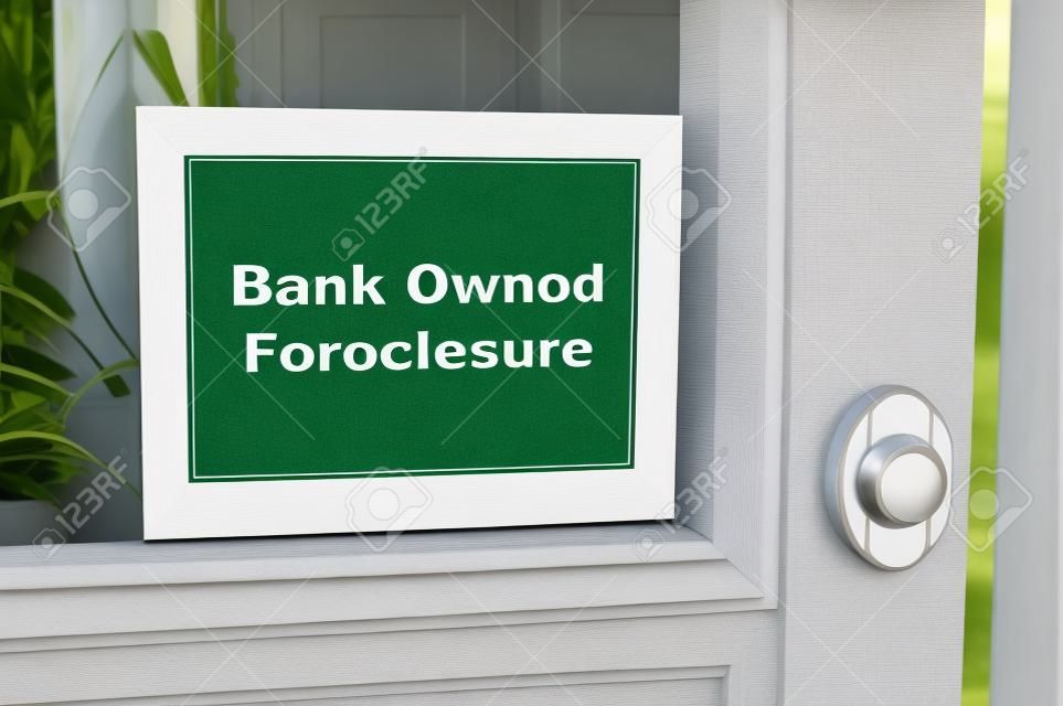 Bank owned foreclosure sign on home.