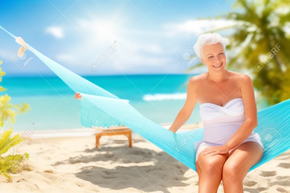 Mature beautiful tourist woman relaxing at the beach