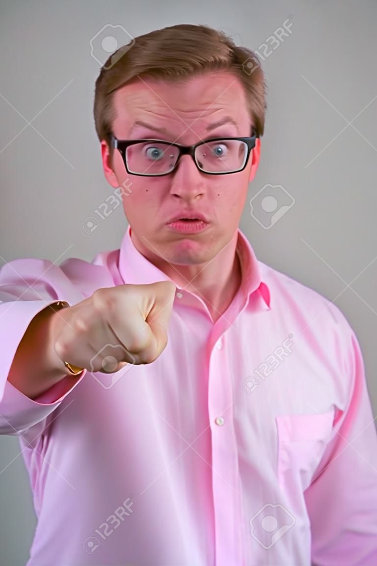 Face of angry young nerd businessman giving thumbs down