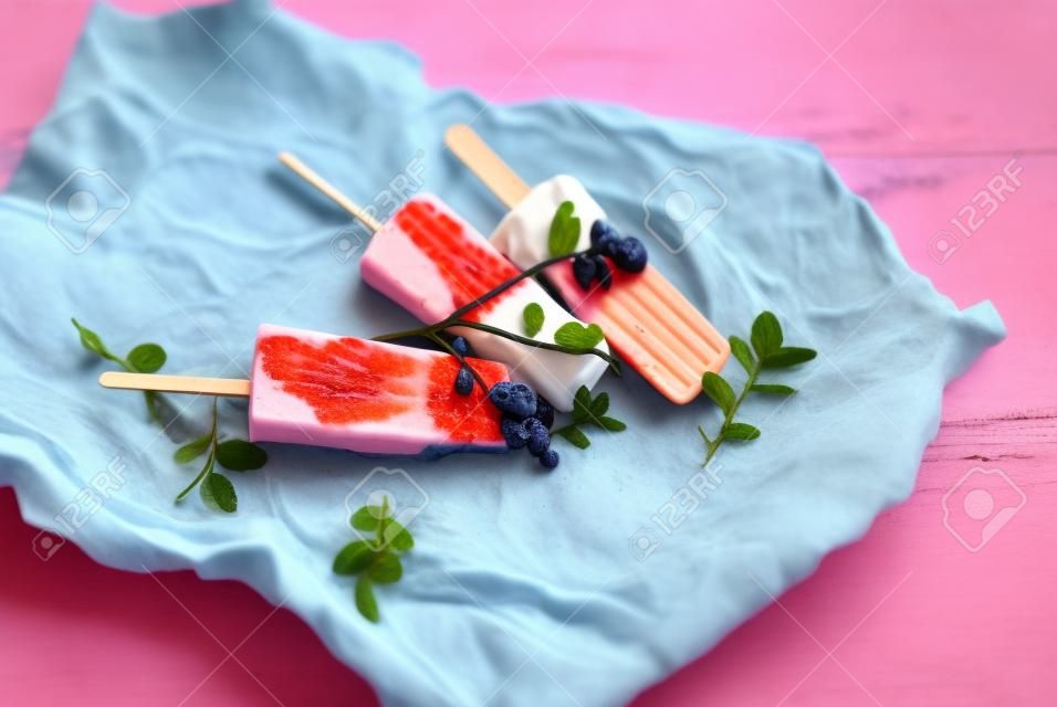Popsicle with yogurt, blueberries and strawberries