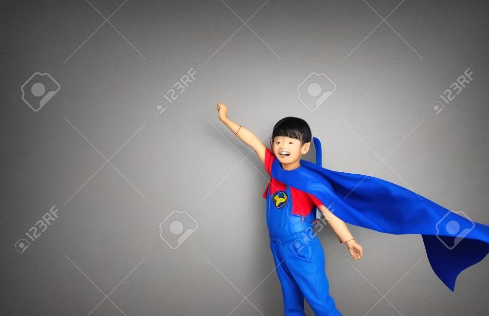 Asian child acting to be superhero.Imanigination and success concept.Play creative thinking in kid.