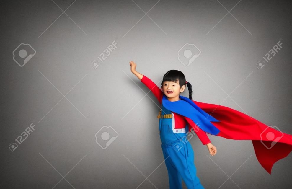 Asian child acting to be superhero.Imanigination and success concept.Play creative thinking in kid.