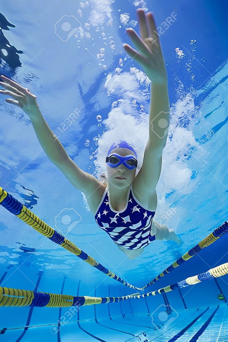 Woman swimming underwater (low angle view)