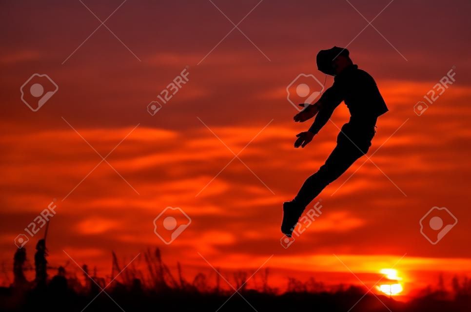 Guy jumping over sunset.