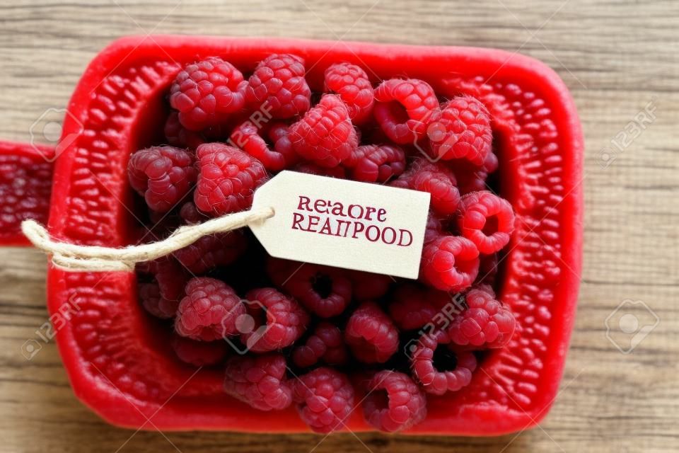 Eat more real food, raspberries and a tag with the inscription