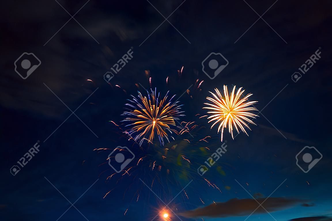 Fireworks in sky twilight. Fireworks display on dark sky background. Independence Day, 4th of July, Fourth of July or New Year.