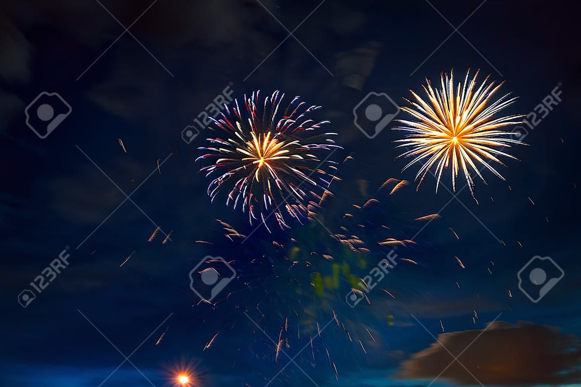 Fireworks in sky twilight. Fireworks display on dark sky background. Independence Day, 4th of July, Fourth of July or New Year.