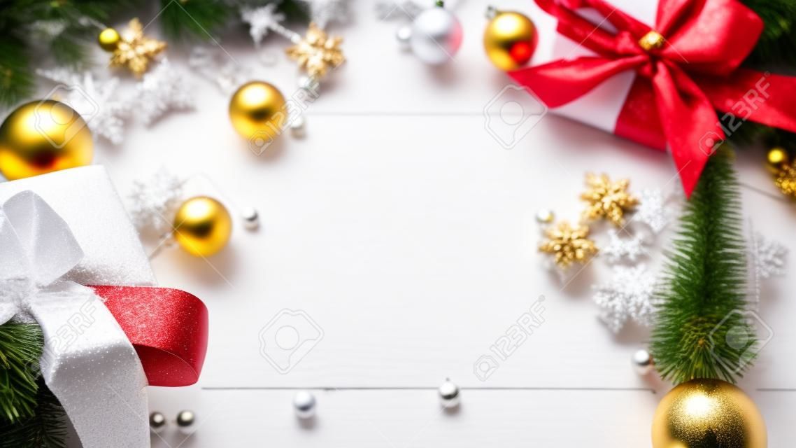 Christmas frame. Winter wooden decoration background. Xmas board with old rustic wall, white frozen snow, golden balls and gift box. New year with copy space