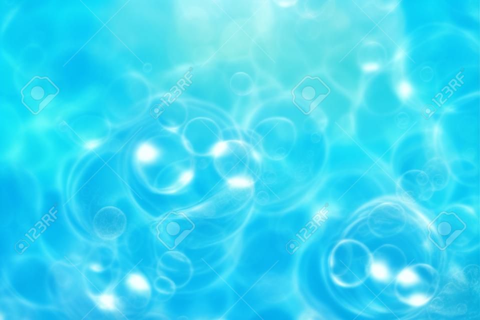 太陽の反射、波状の水の中の泡の束。青のテクスチャ背景。クローズアップ、選択フォーカス、デフォーカス