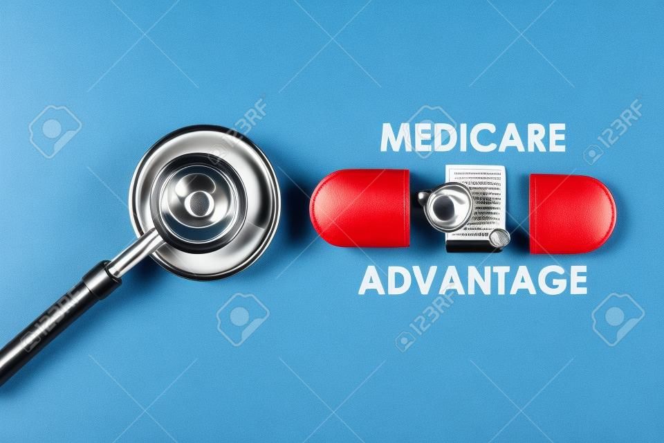 A picture of stethoscope with fake capsule, medicare advantage word, tablet, money shield and heart.