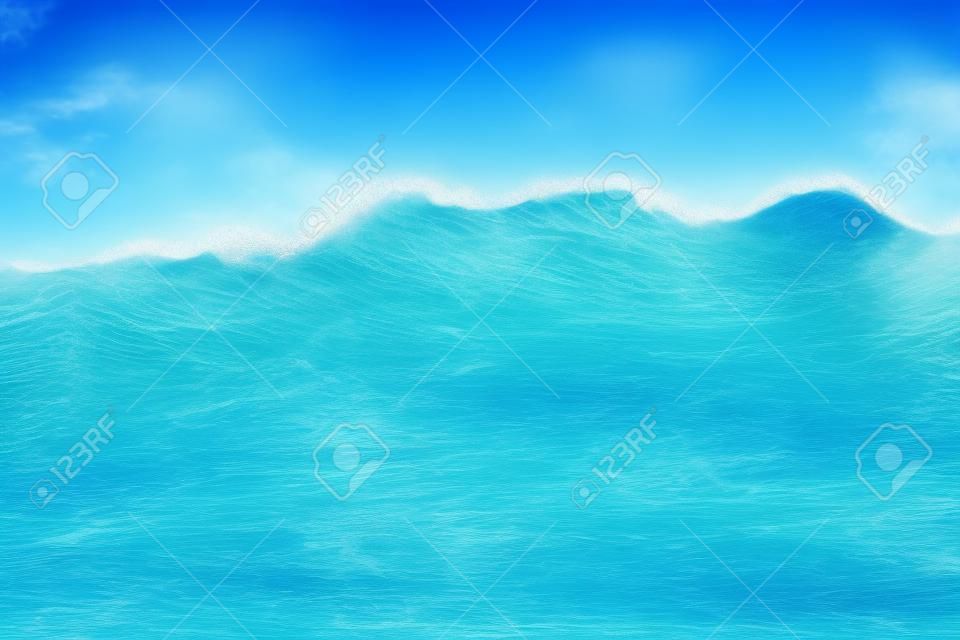 Immagine di sfondo dell'onda morbida dell'oceano blu sulla spiaggia sabbiosa. Fine dell'onda di oceano in su con lo spazio della copia per testo