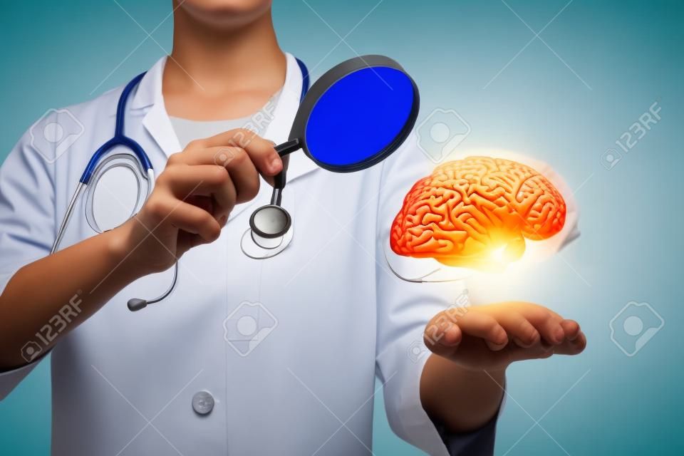 A young doctor with a magnifier is standing and looking at the brain model hanging above her hand at the blurred laboratory background. The concept of innovative approach in brain researching.