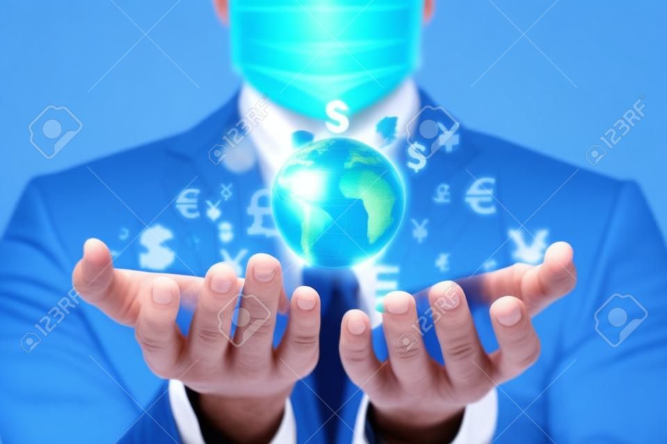 Masked businessman supports global business on a blue background.