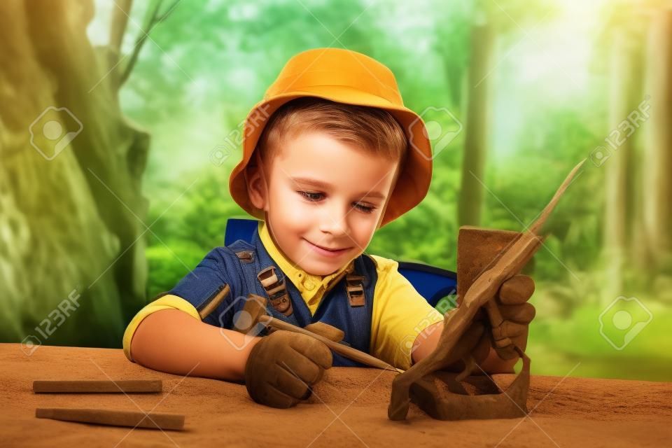 Niño pequeño lindo quiere ser un arqueólogo