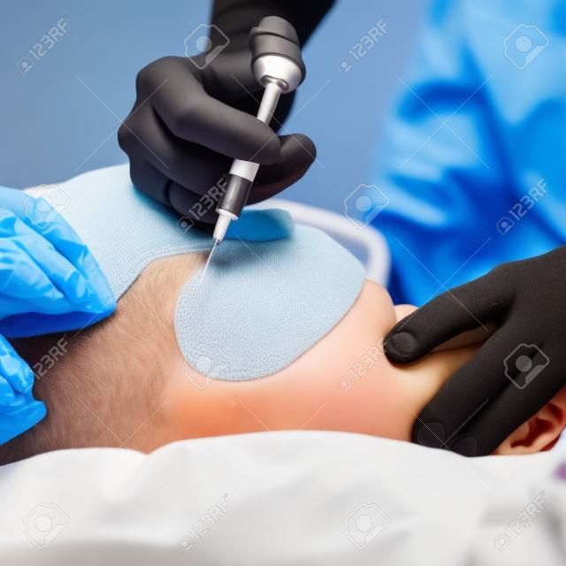 Doctor giving a child an intramuscular injection, shallow DOF