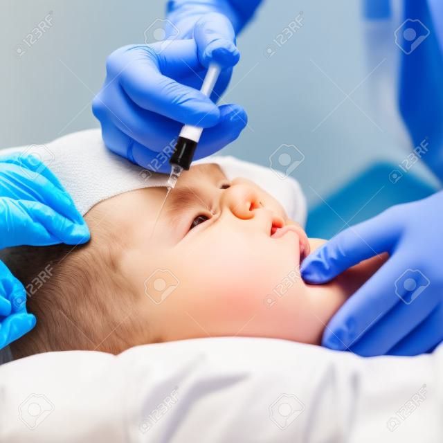 Arzt gibt einem Kind eine intramuskuläre Injektion, shallow DOF