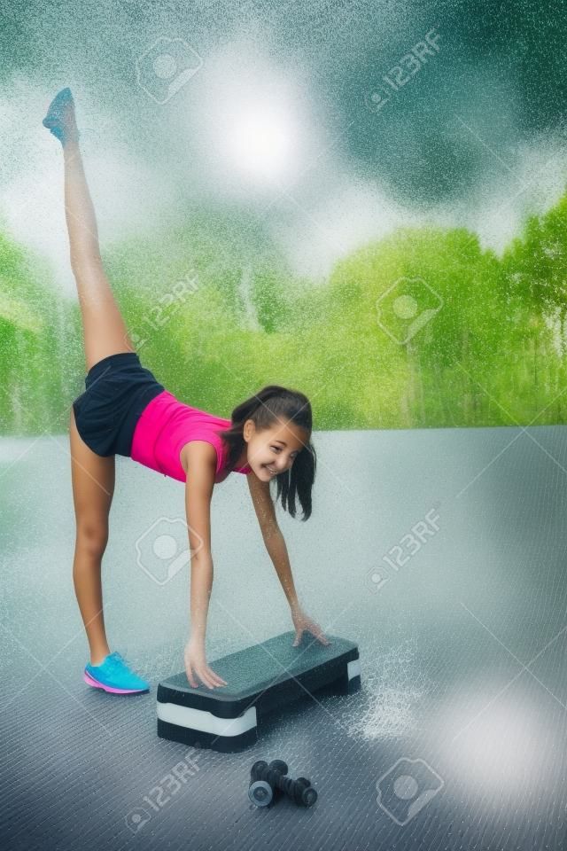 A cute, pretty teenage girl performs various outdoor exercises. Lifestyle