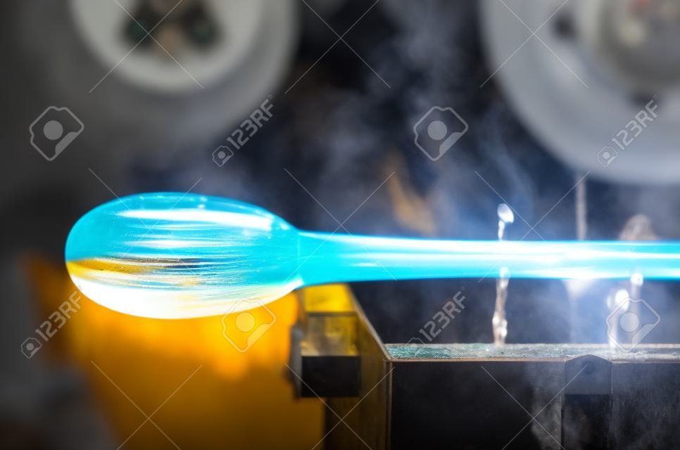 Glass blower manufacturing process, moment of cooling the glass  at a glass makers workshop