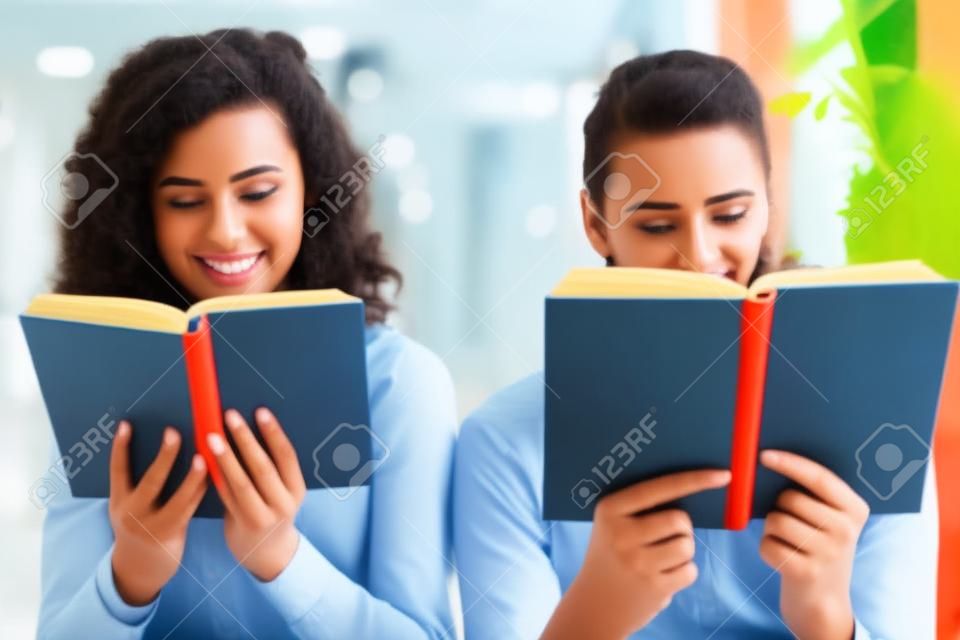 Young university students reading books and studying