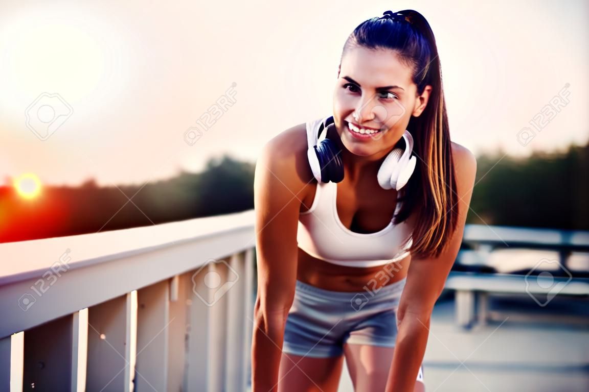 Portrait of woman taking break from jogging
