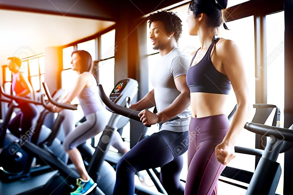 Fröhliche, fitte Freunde, die trainieren, im Fitnessstudio trainieren, um gemeinsam gesund zu bleiben