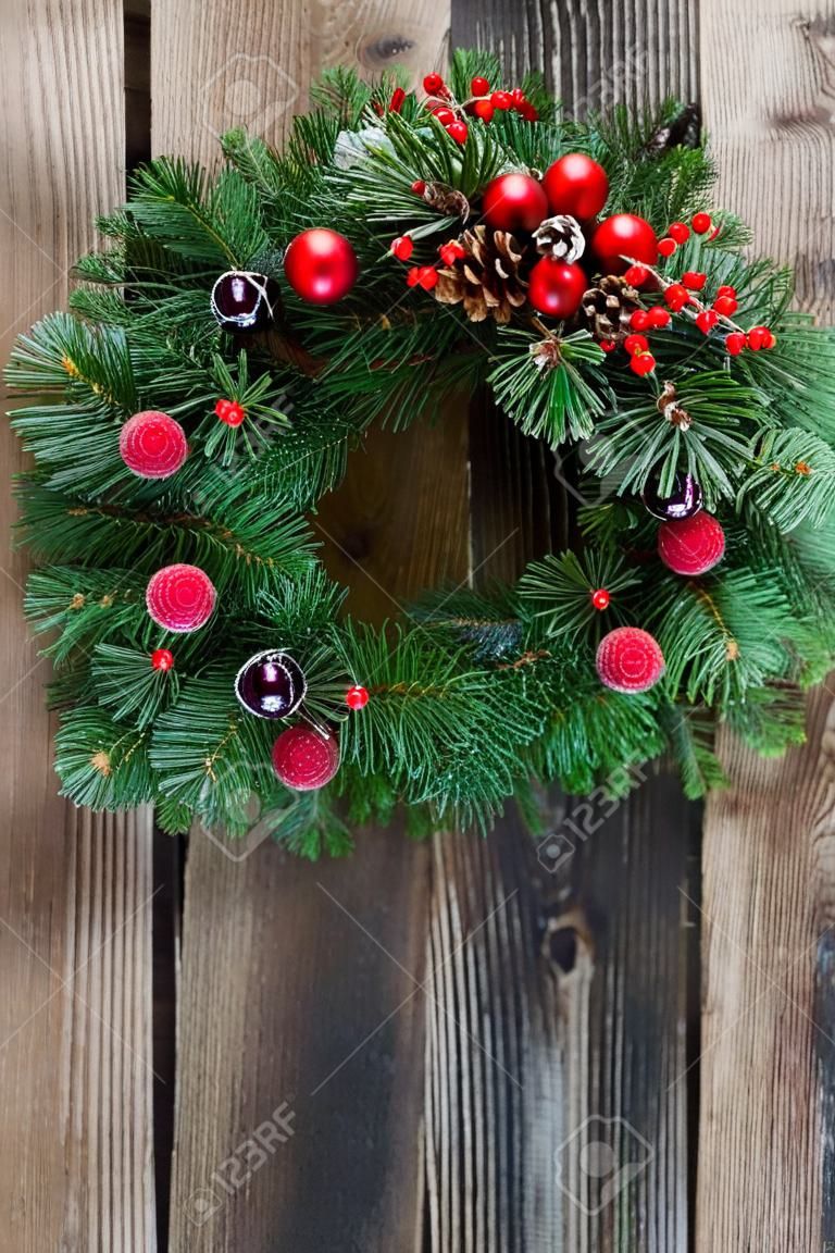 christmas decorated evergreen  wreath  on  aged wooden  background