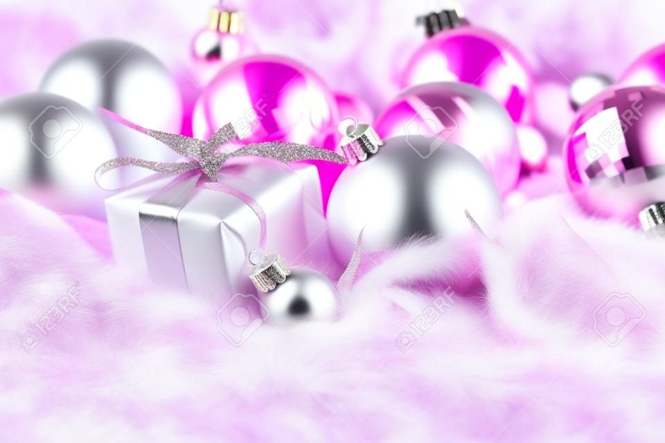 Pink Christmas decorations on white fur background, retro toned