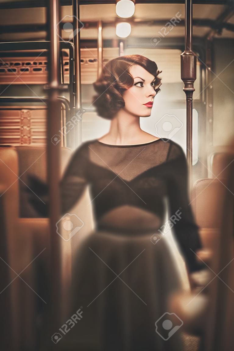 Beautiful vintage style young woman inside retro train coach 