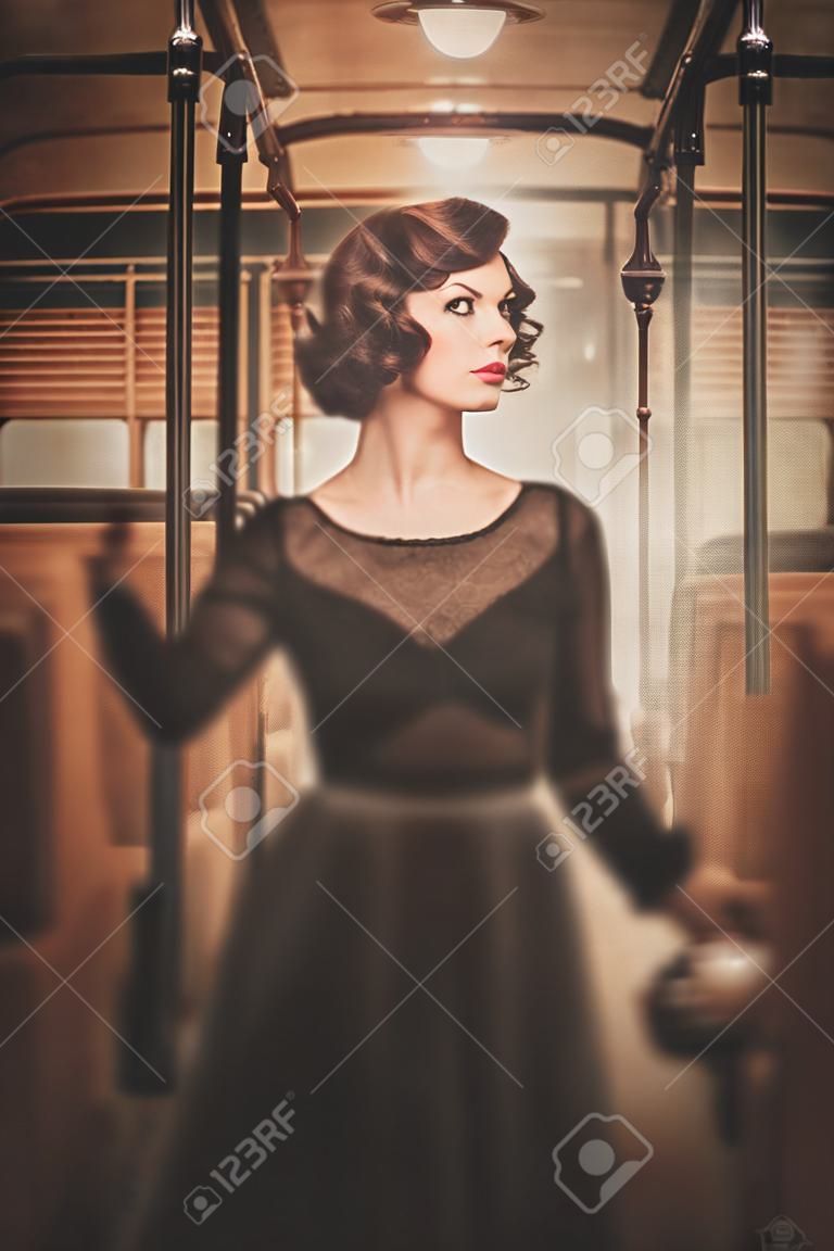 Beautiful vintage style young woman inside retro train coach 