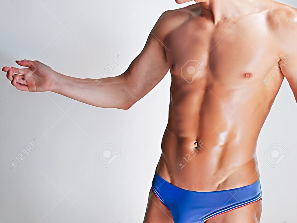 Young man's muscular torso in underwear