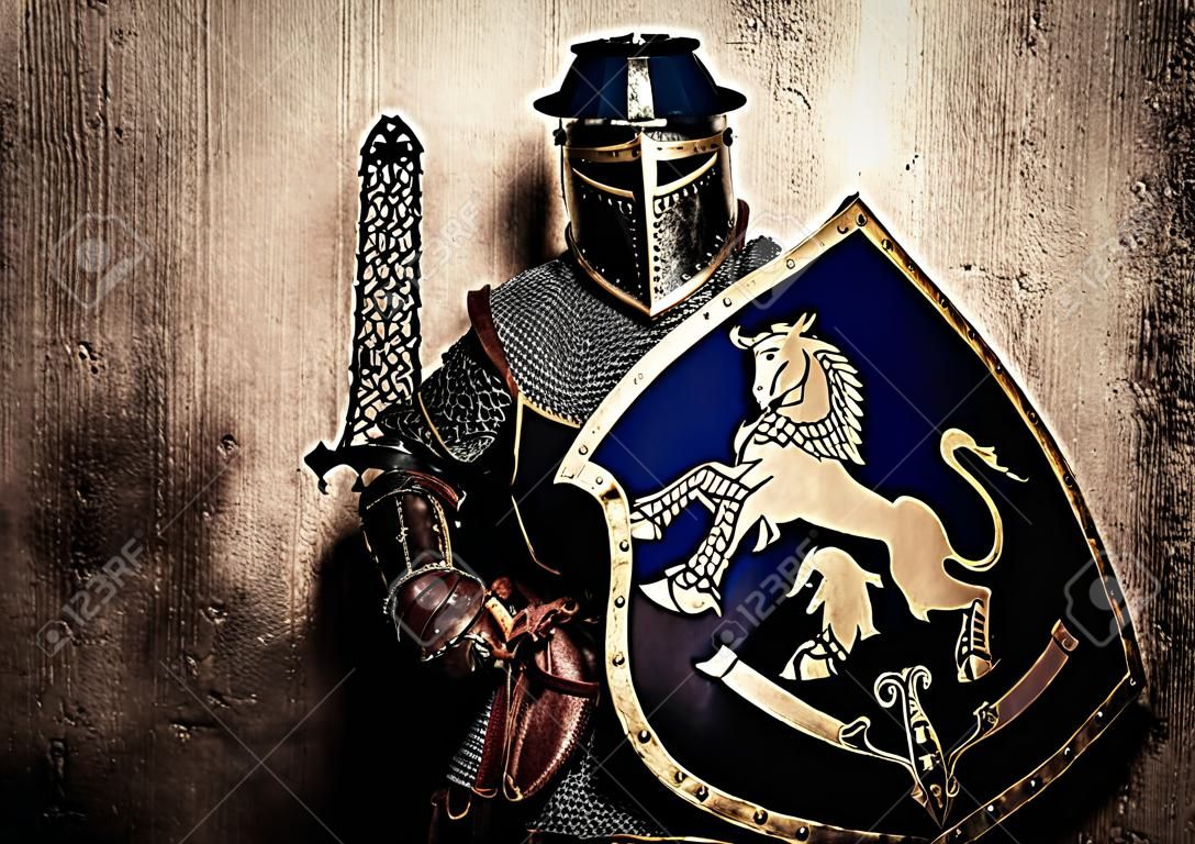 Medieval knight on golden wall background