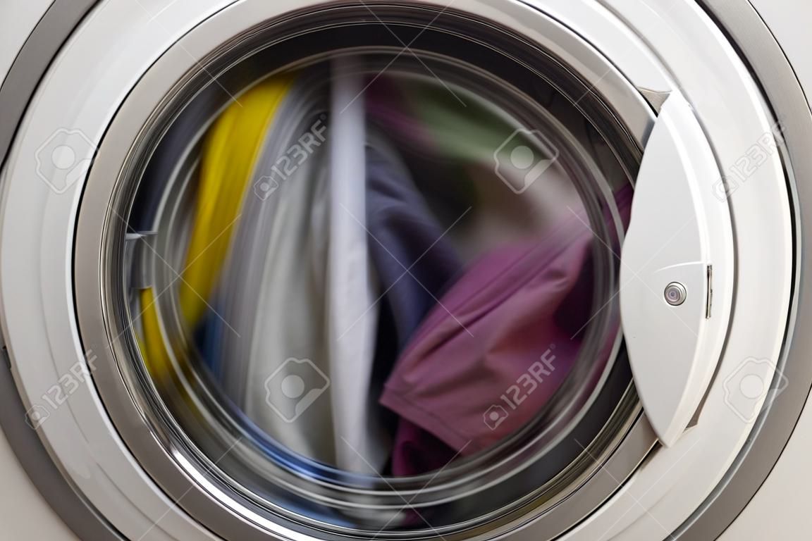Washing machine door with rotating garments inside