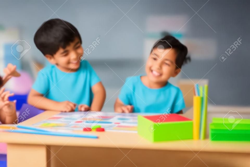 Boy and girl playing educational games in the school class