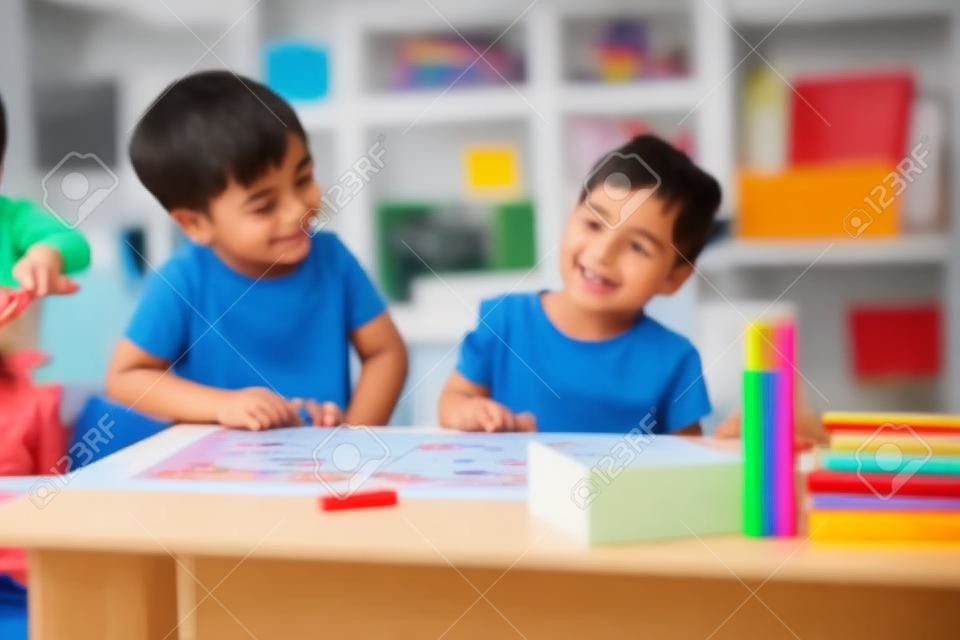 Boy and girl playing educational games in the school class