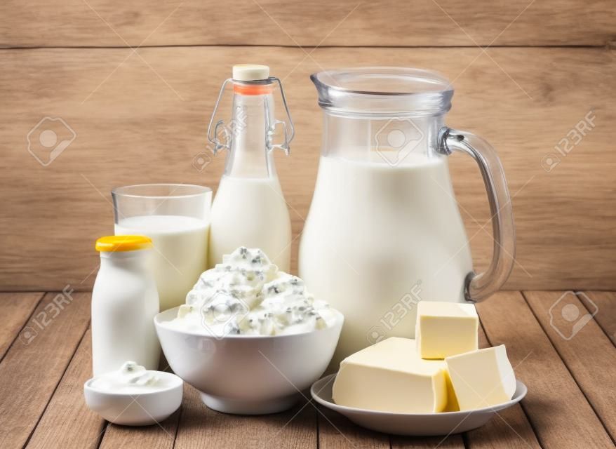 Dairy products, milk, cottage cheese, yogurt, sour cream and butter on wooden table