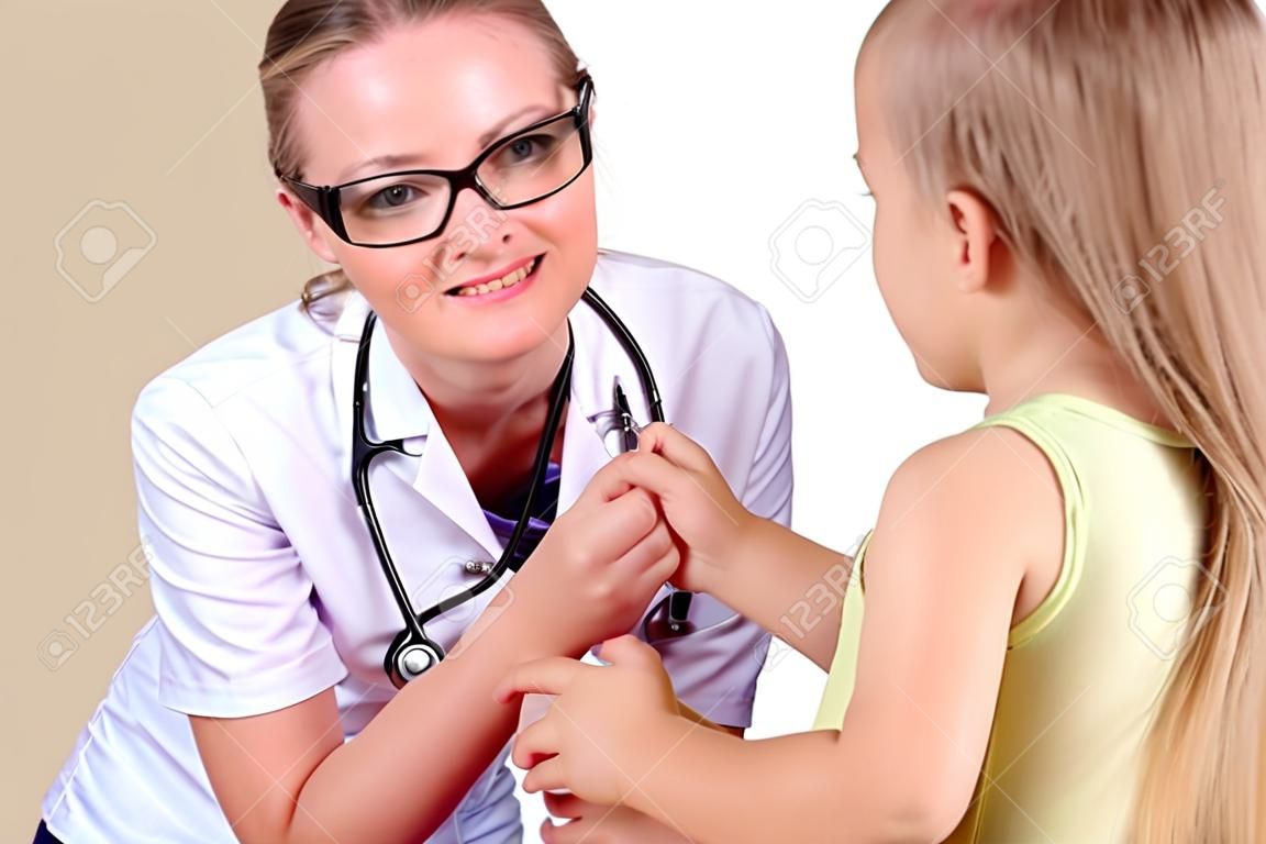 Young female doctor doing medical examination to a child