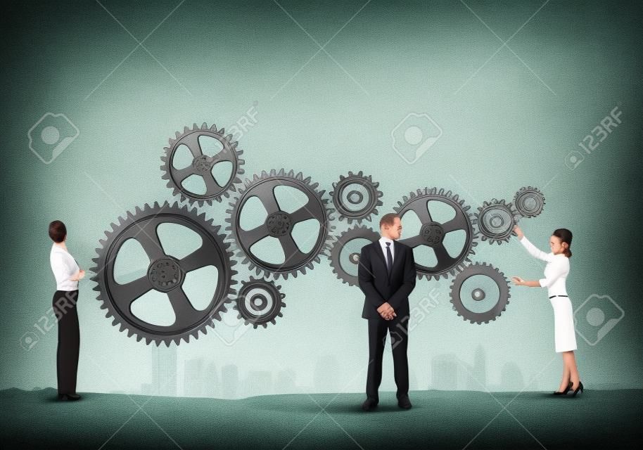 Businessman and businesswoman with cog wheel elements  Organization concept