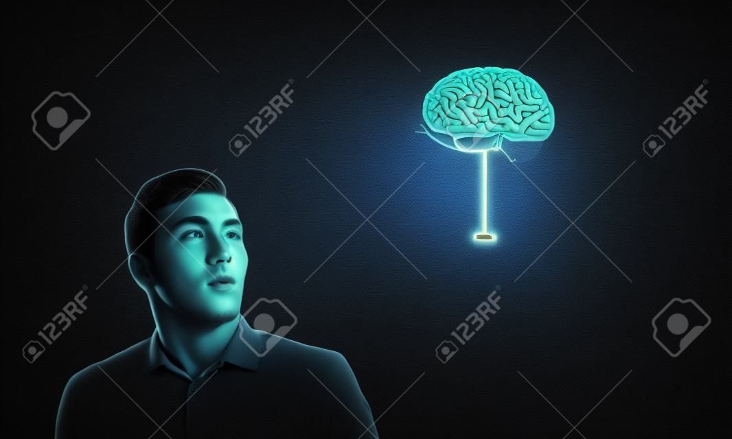 Young man and brain illustration against dark background