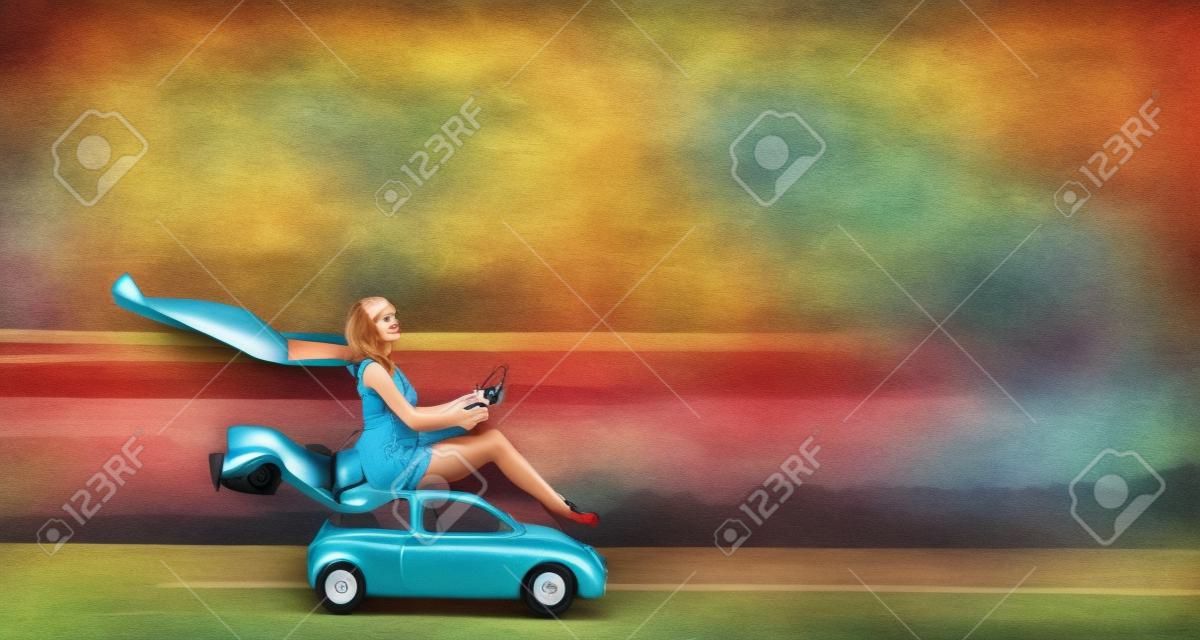 Pretty woman sitting on toy car with steering wheel in hands. Mixed media
