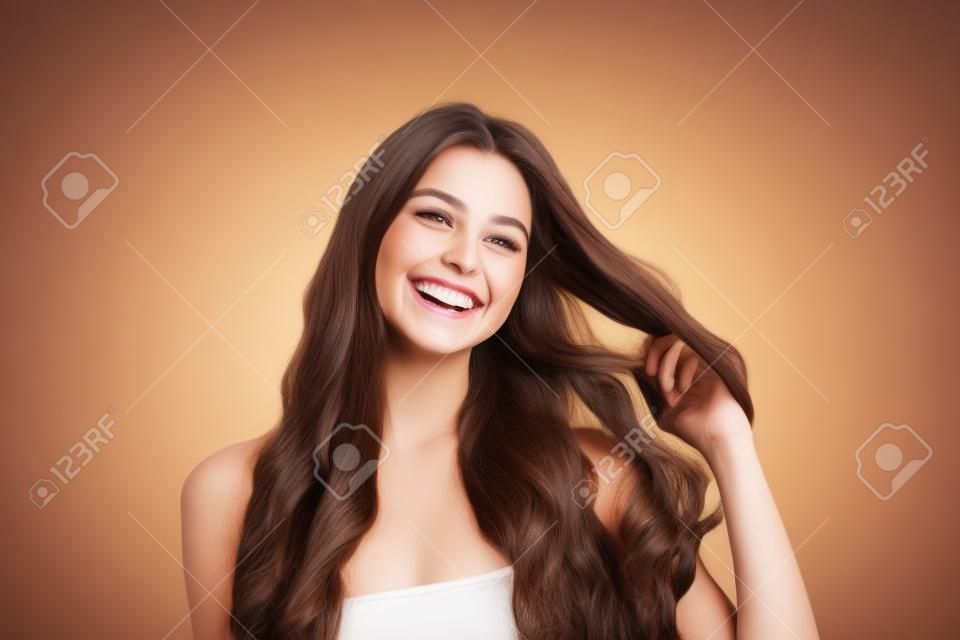 Young cheerful carefree joyful brunette female laughs happily with pleasure